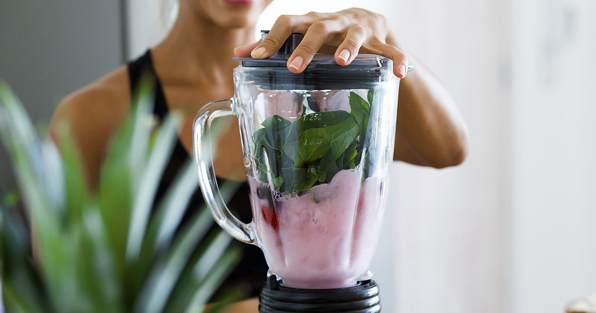 woman blending a smoothie