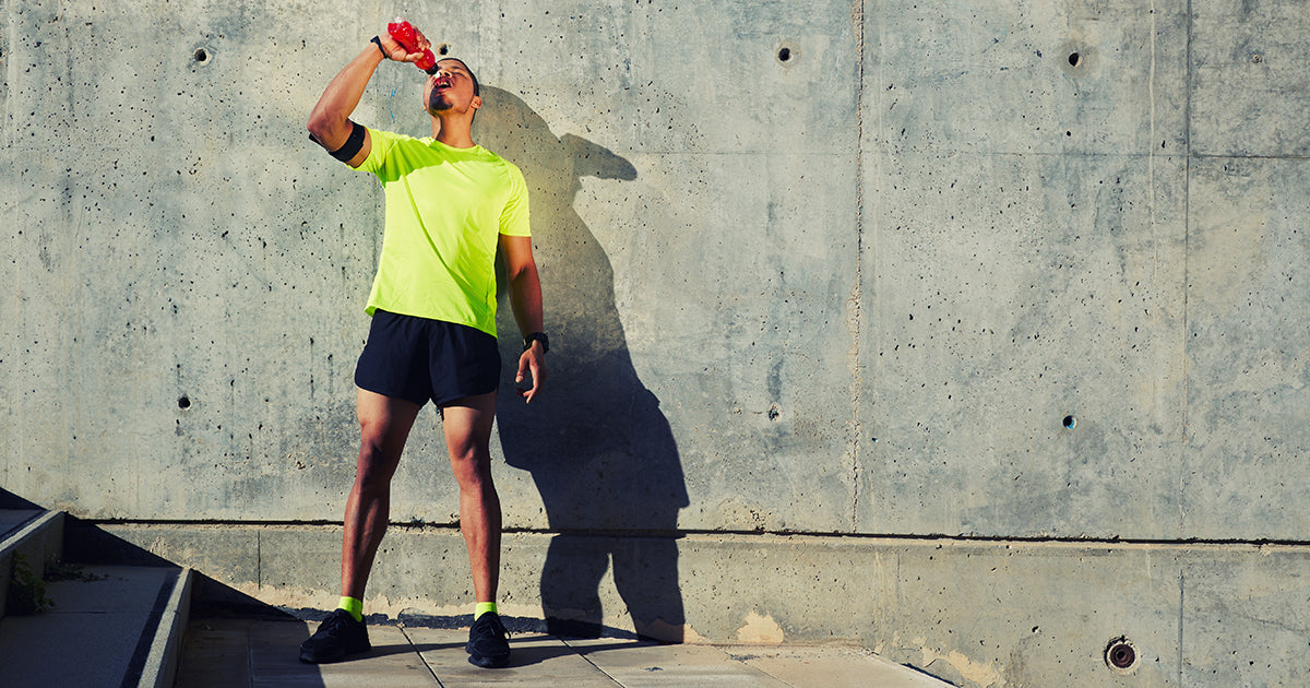 man drinking from water bottle