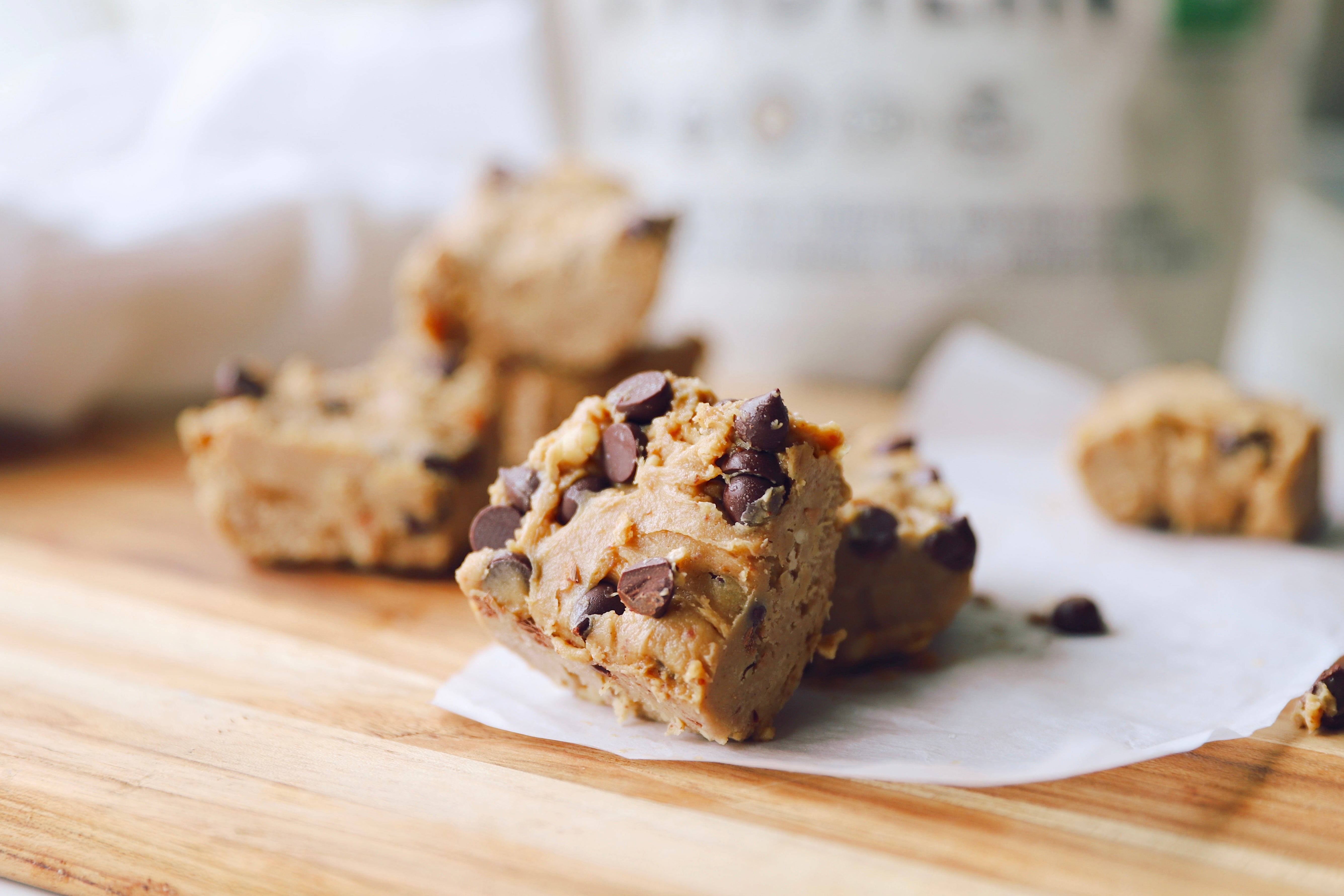 Peanut Butter Chocolate Chip Protein Bars on a rustic wood board